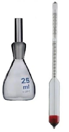 Szklane naczynie z korkiem z napisem 25 ml i smukły szklany przyrząd z podziałką